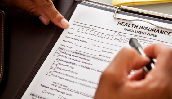 Photo of a person filling out a health form.