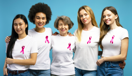 Women wearing pink breast cancer ribbons.